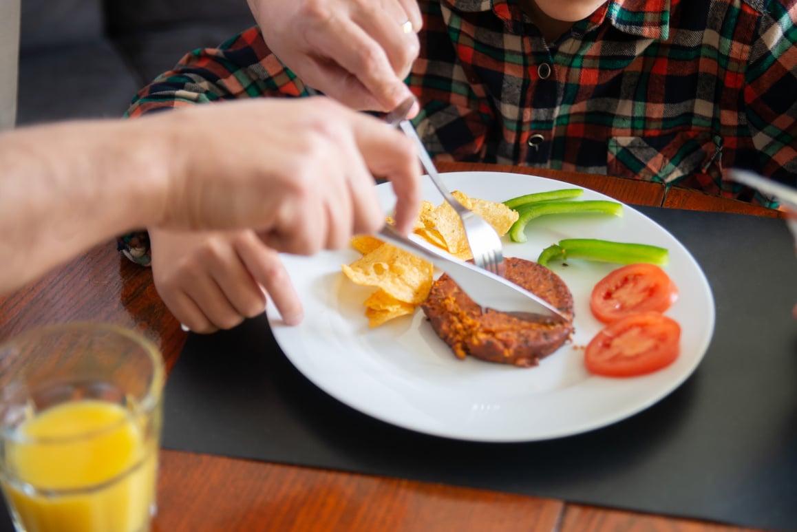 Person slicing a Patty
